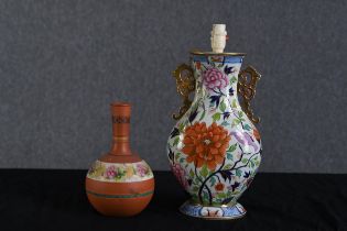 A lamp and vase both in a floral decoration. Twentieth century. The lamp measures H.45 W.21 D.14 cm.