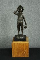 A bronze figure on a wooden plinth. Boy carrying water. Signed by the artist and with a Parisian