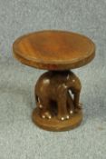 A carved hardwood elephant stool. H.36 Dia.35cm.