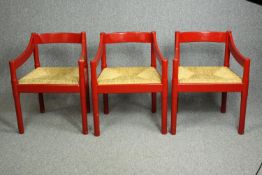 Vico Magistretti (1920-2006), a set of three 1960s Carimate armchairs, red lacquered with woven