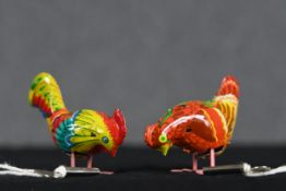 Two wind up toy chickens. Lithographed tin. Complete with their keys. H.6 W.10 D.4 cm.
