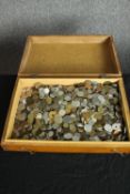 An extensive coin collection housed in a wooden box. Includes British and international coins.