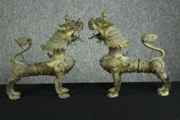 A matching pair of brass dragons or foo dogs. Twentieth century. H.30 W.26cm.