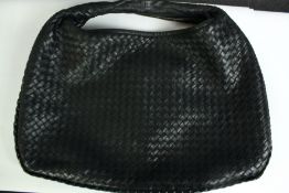 A small Bottega Veneta Intrecciato black leather handbag. With a suede lining and calf leather