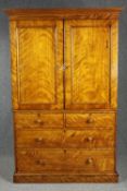 Linen press, mid 19th century satin birch in two sections with linen slides on plinth base. H.204