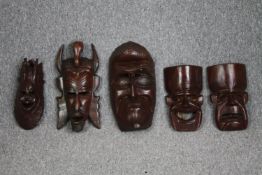 Five 20th century carved African tribal masks. H.40 W.20cm. (largest)