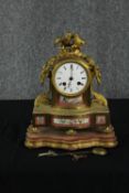 A French 19th century gilt bronze mantle clock with hand painted floral porcelain plaques, two doves