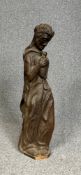 An early 20th century oak carving of a robed man holding a bird. H.82 L. 25.