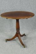 Occasional table, early 19th century mahogany with a tilt top action. H.71 W.76 D.51cm.
