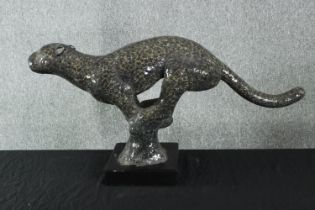 A large Jaguar wild cat figure. H.45 W.88cm.