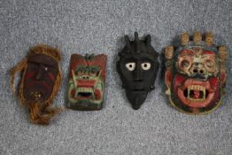 Four painted tribal masks. The largest measures H.32 W.22cm.
