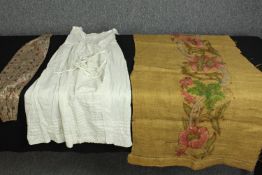 A collection of textiles, including hand embroidered panel with floral and foliate design along with