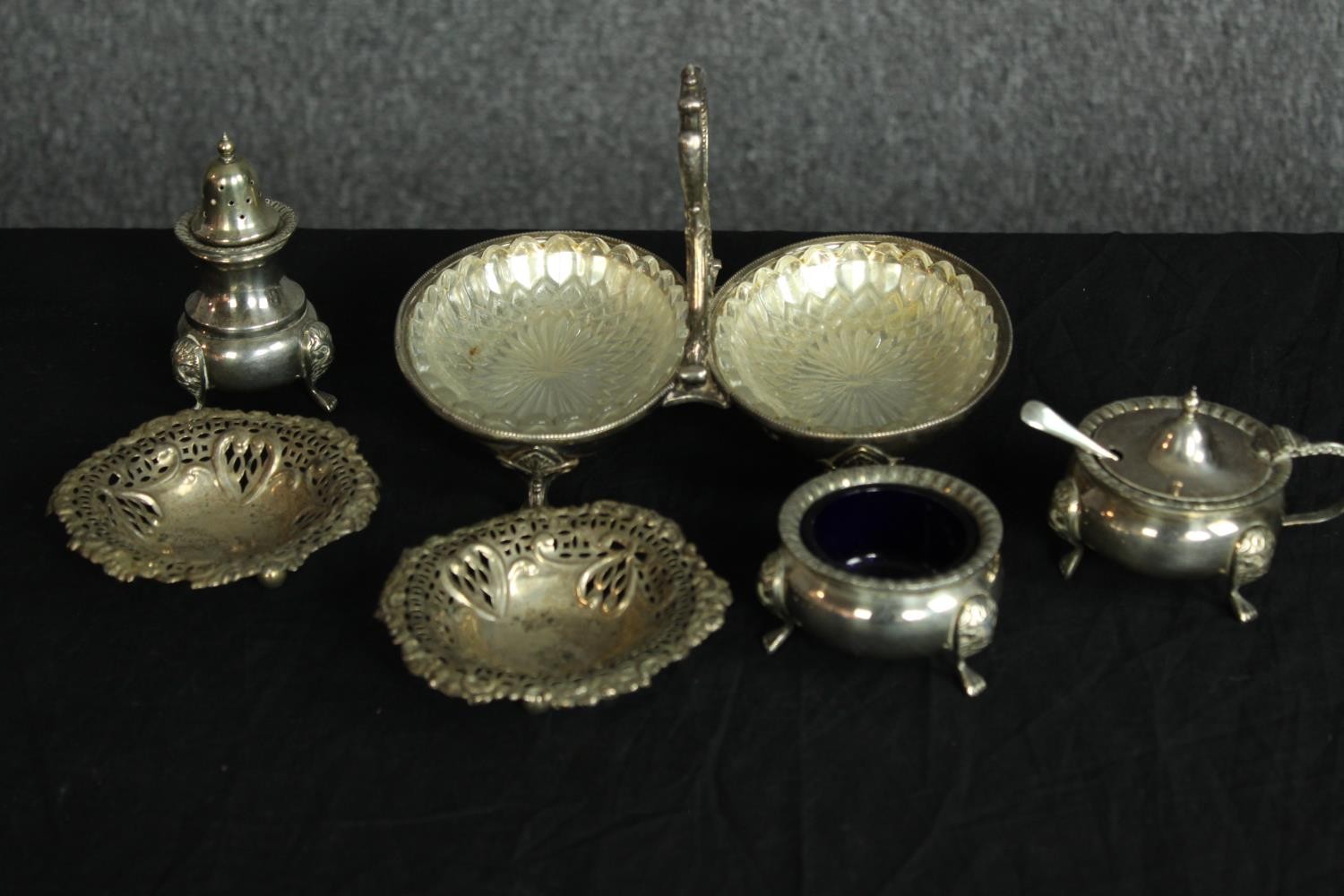 A pair of hallmarked silver bon bon dishes with pierced floral decoration along with a silver plated