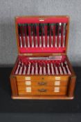 A mid-century mahogany canteen of matched silver cutlery for twelve people. Various makers and