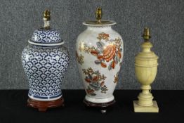 Three 20th century table lamps, including a Chinese blue and white lidded urn lamp, a carved