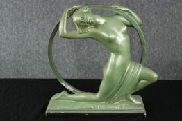 An Art Deco painted plaster figure of a dancer with a hoop. Impressed mark. H.38 W.34 D.10cm.