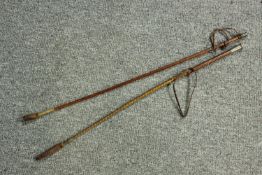 Two early 20th century leather riding crops, one with a white metal end. L.69cm.