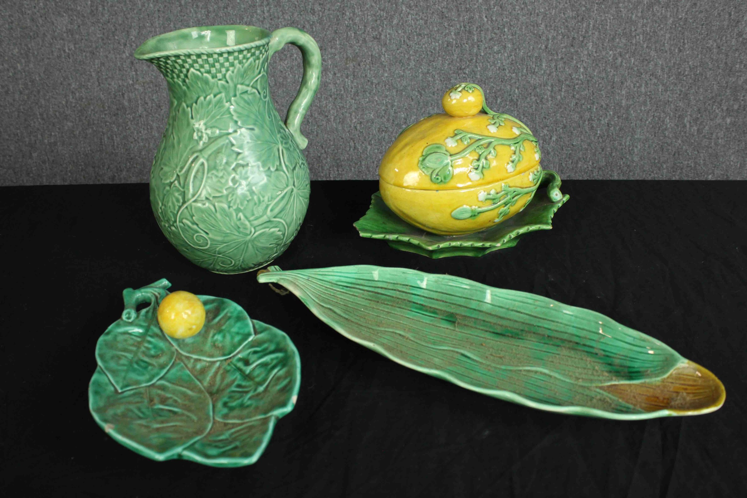 A collection of green and yellow porcelain made by 'L&H' Pottery. Two dishes, a jug, and a lemon