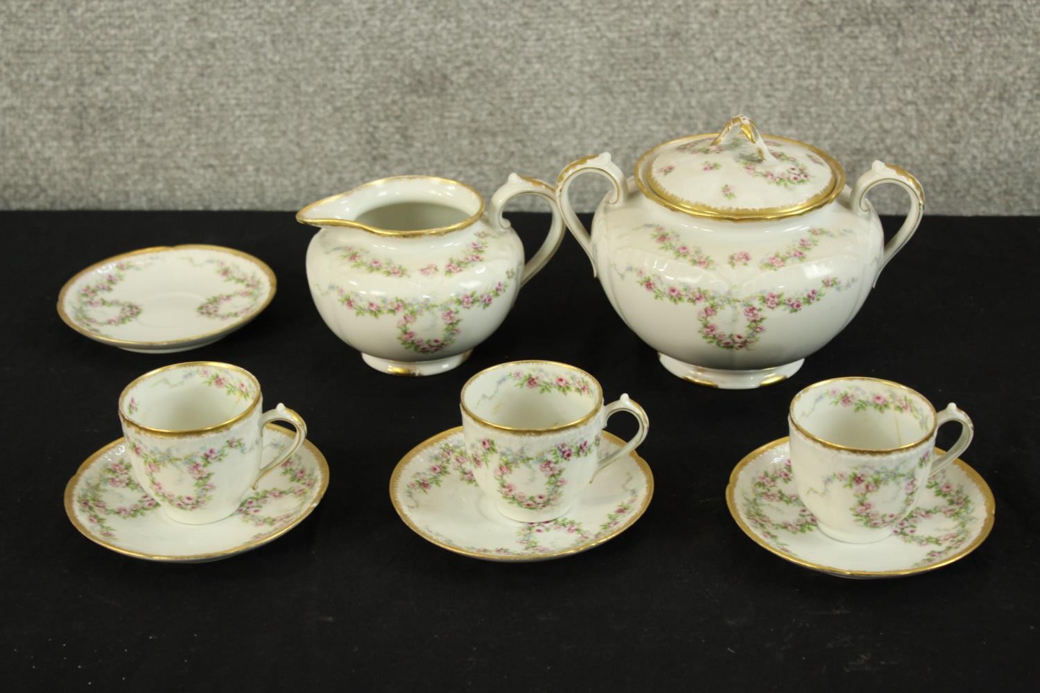 A collection of decorative G.D.A pottery to include a jug, three cup and saucer, a pot and a