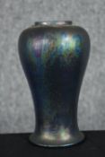 An early 20th century Ruskin pottery vase, with mottled metallic glaze on black ground. Maker's