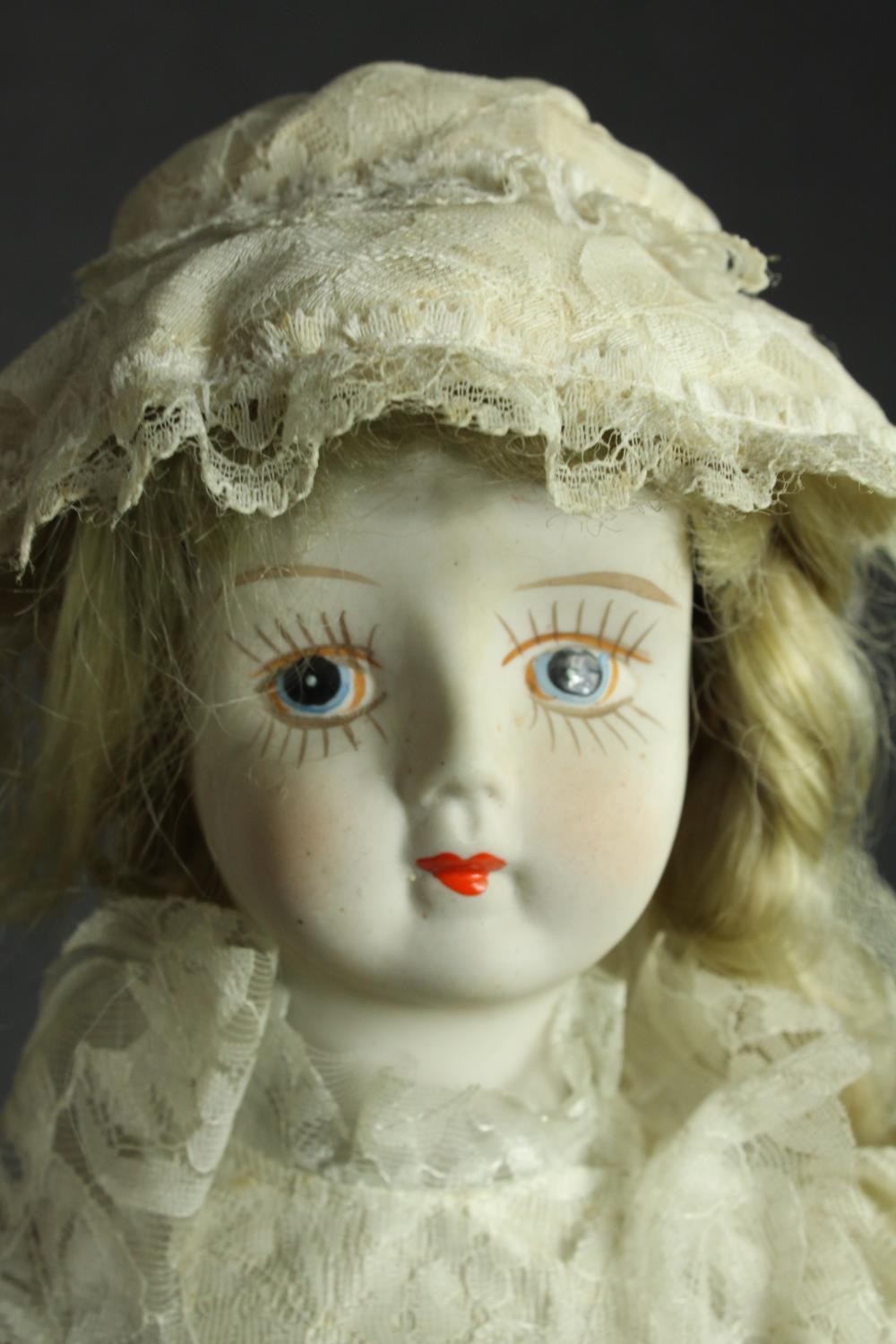 A ceramic bride doll with a hand painted face and lace clothing. Early twentieth century. H.47cm. - Image 2 of 5