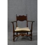 A small low oak open armchair. H.80cm