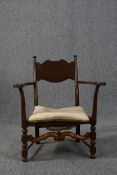 A small low oak open armchair. H.80cm