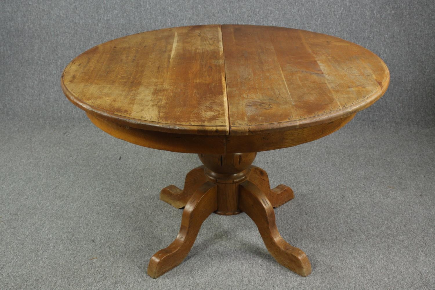 Dining table, Victorian style oak with two extension leaves. H.76 Dia.120cm.