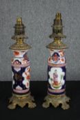 A pair of early 20th century Imari style hand painted porcelain and brass converted oil lamps