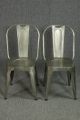 A pair of metal vintage industrial style dining chairs.