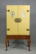 A mid century cabinet on stand with hand painted panels. H.141 W.72 D.43cm.