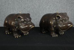 A pair of large bronze bulldogs with spiked collars and jowled faces. H.25 W.46 D.20cm. (each)