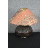 A carved hardwood lamp. Decorated with a tribal relief pattern. H.45 cm.