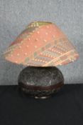 A carved hardwood lamp. Decorated with a tribal relief pattern. H.45 cm.