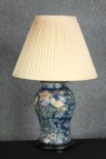 A hand painted porcelain lamp with a William Morris type design. H.86 cm.