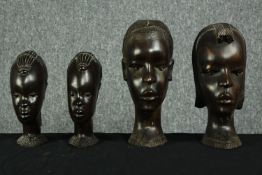 Four African carved hardwood female busts with well detailed head dress and plaited hair. H.36 cm.