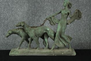 An Art Deco plaster figure. Women walking two Borzoi dogs. Painted patina. H.46 W.54 cm.