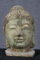 Buddha with domed Ushnisha (symbol of his Enlightenment) metal and polychromed hair. The face has