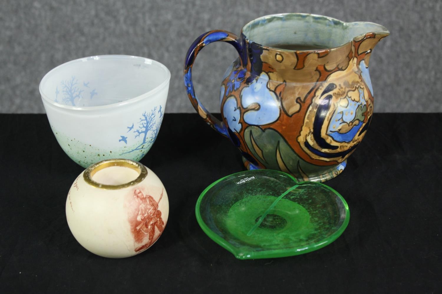 A collection of glass and ceramics, including a Kosta Boda art glass bowl with tree and bird design,