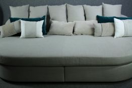 Daybed sofa, contemporary upholstered with a large collection of cushions. H.80 W.275 D.180cm.