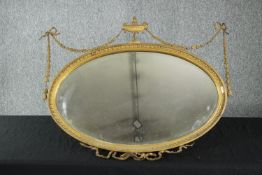 Wall mirror. early 20th century gilt Adam style with urn and husk gesso decoration. H.71 W.87cm.