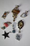 Eight silver and gemstone pedants of various designs. Gemstones include citrine, onyx, amber and