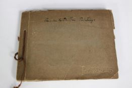 An early 20th century photo album of fifteen images taken at a Persian art exhibition. H.19 W.25 cm.