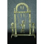A decorative swinging metal candle holder with three cast figures. Probably Indian. No makers