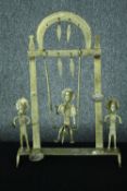 A decorative swinging metal candle holder with three cast figures. Probably Indian. No makers