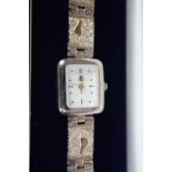 A boxed sterling silver Brooks Bentley 'footprints' watch with articulated bracelet. Rectangular