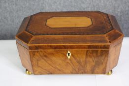 A 19th century walnut box with satinwood and ebony inlay with brass lion mask handles raised on ball