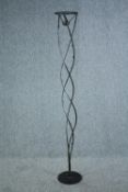 A floor standing decorative iron candle holder. H.170cm.