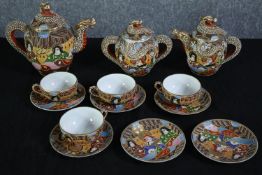 A late 20th century Japanese geisha design tea set. Incomplete. With two teapots, a sugar bowl, four