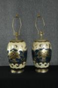A pair of 20th century Japanese ceramic lamps with stylised metallic floral design on a cream